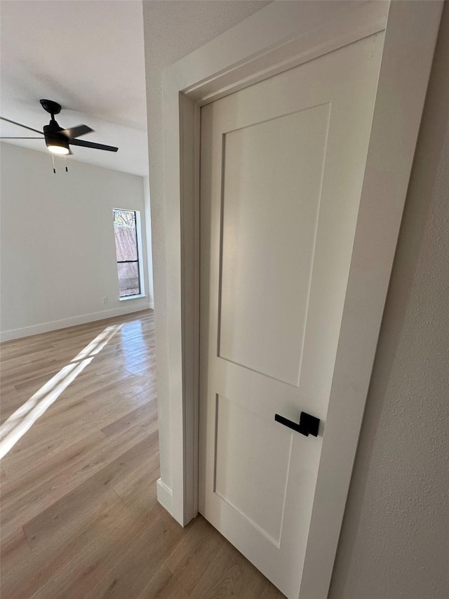 hallway with light hardwood / wood-style floors