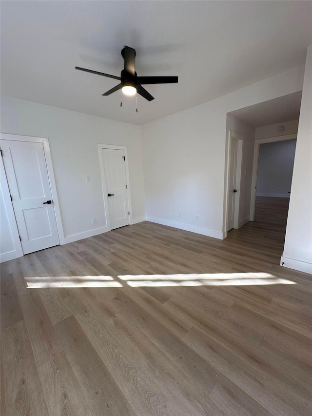 unfurnished room featuring ceiling fan and light wood-type flooring