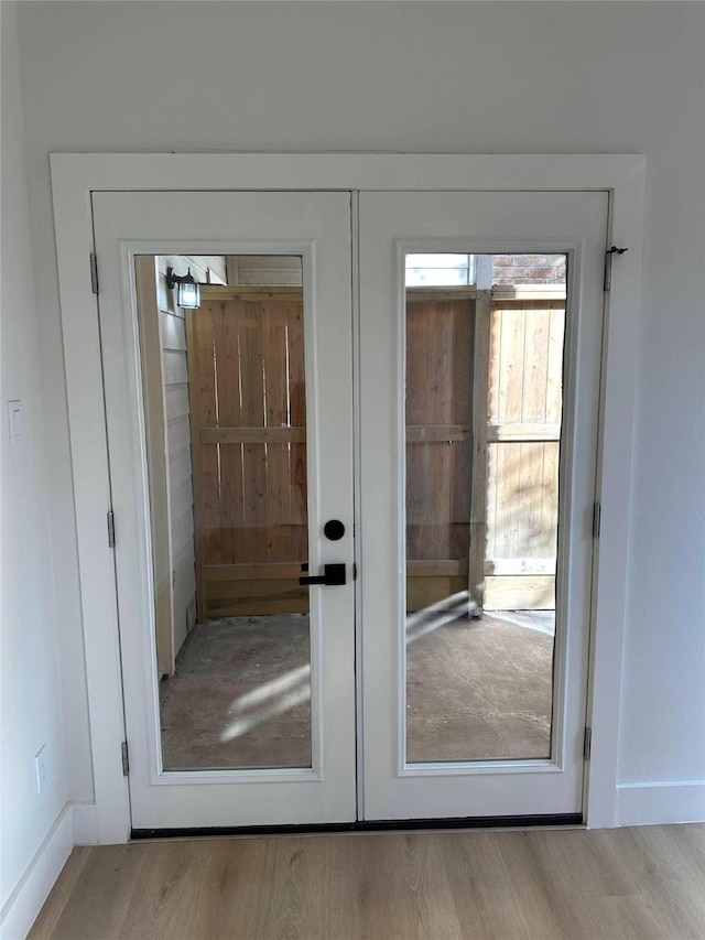 doorway featuring light wood-type flooring and french doors