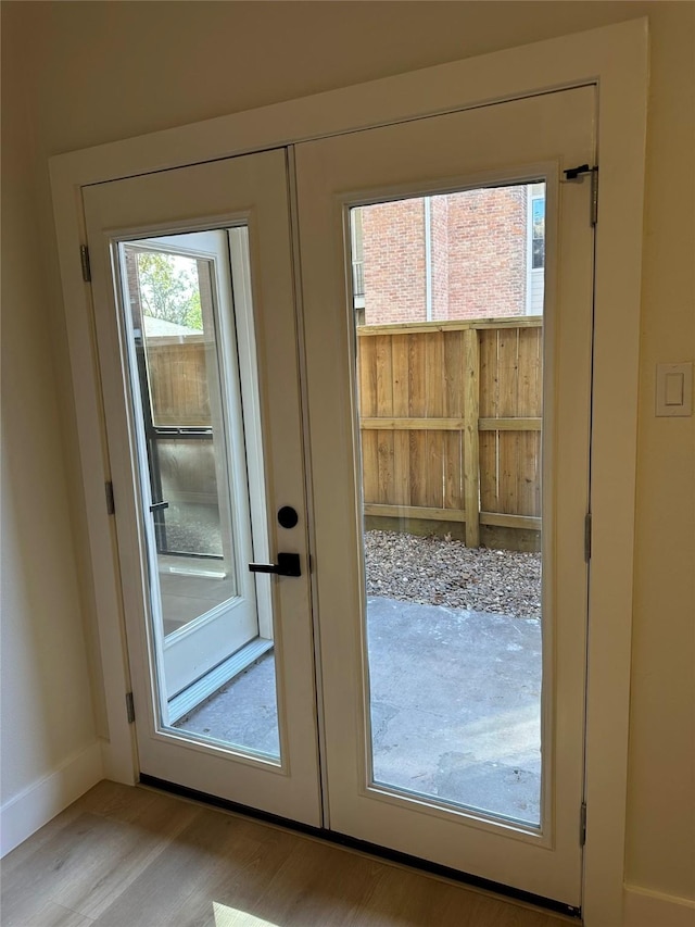 doorway to outside featuring french doors and light wood-type flooring