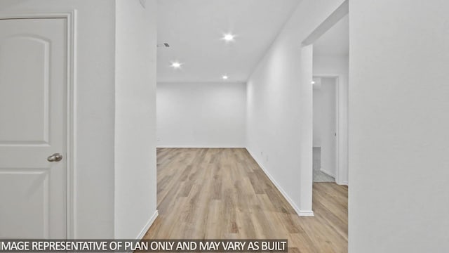 corridor with light hardwood / wood-style flooring