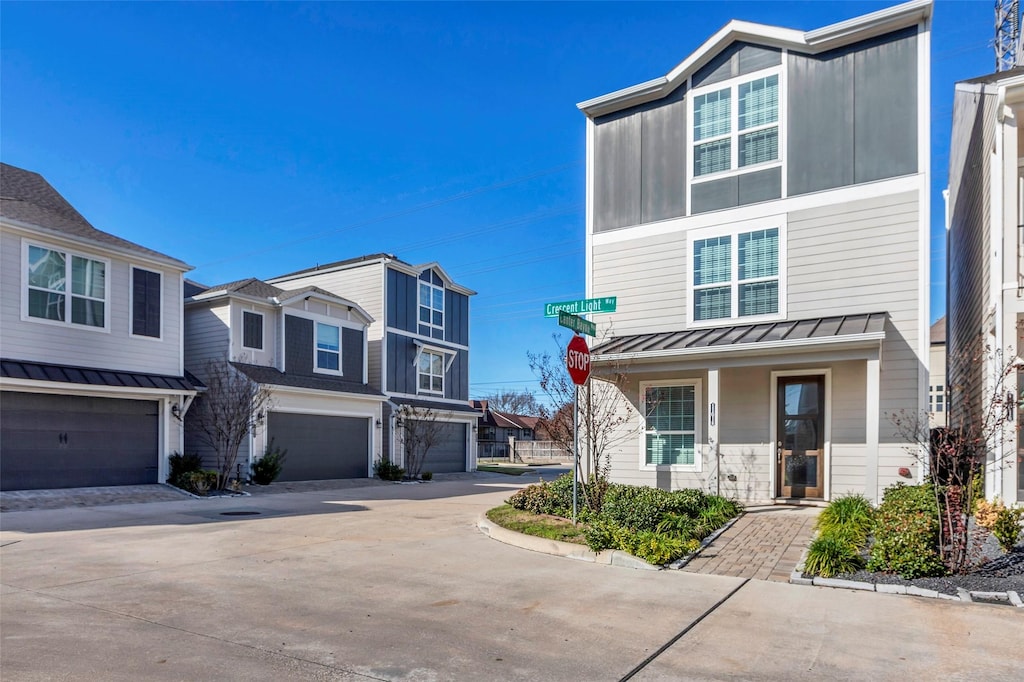 multi unit property featuring a porch and a garage