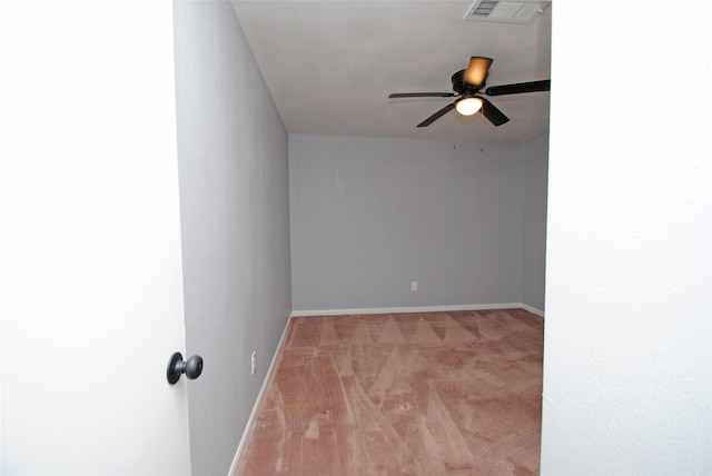 spare room featuring light carpet and ceiling fan