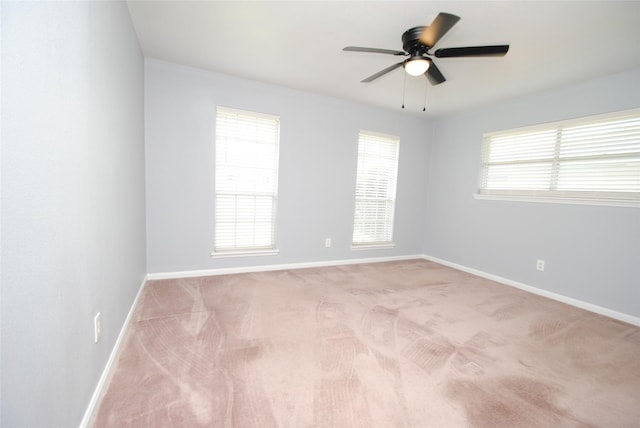 unfurnished room with ceiling fan and light carpet