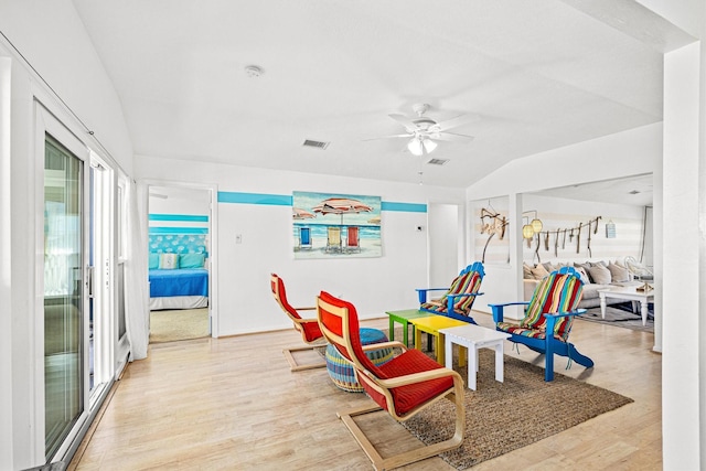 recreation room with ceiling fan, light hardwood / wood-style flooring, and vaulted ceiling