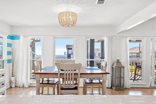 dining space with a chandelier and light wood-type flooring