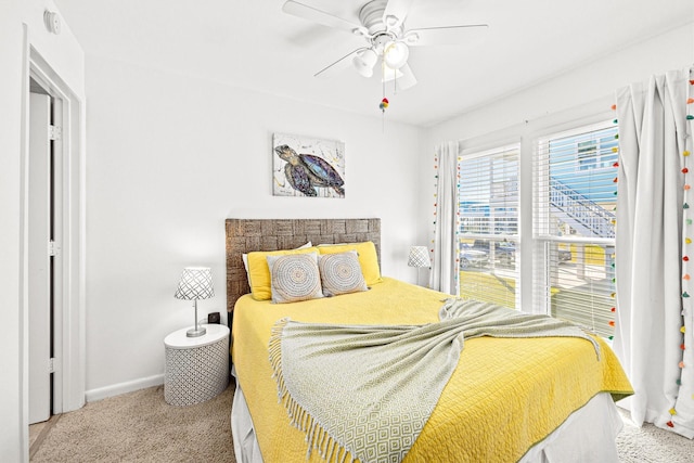 bedroom with ceiling fan and light colored carpet