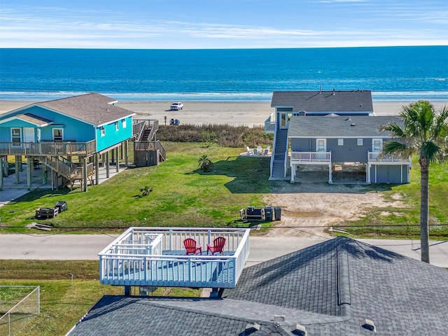 aerial view with a water view and a beach view