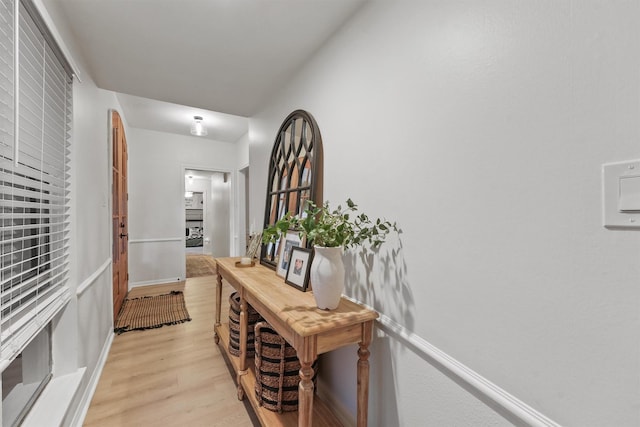 corridor with light hardwood / wood-style flooring