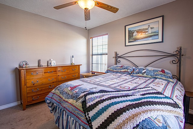 bedroom featuring a textured ceiling, ceiling fan, and carpet flooring