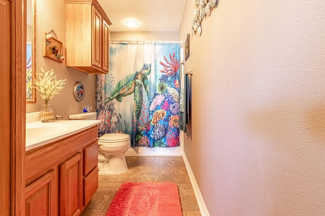 bathroom featuring toilet, vanity, a shower with shower curtain, and a textured ceiling