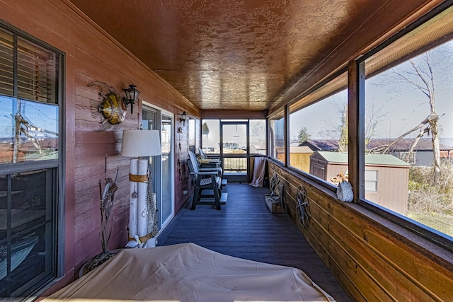 sunroom featuring wooden ceiling and a wealth of natural light