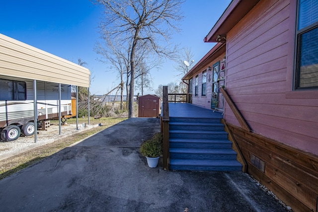 view of side of home featuring a storage shed