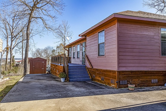 view of home's exterior with a storage shed