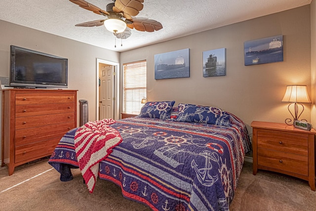 bedroom featuring a textured ceiling, ceiling fan, and carpet flooring