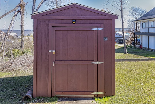 view of outbuilding featuring a lawn