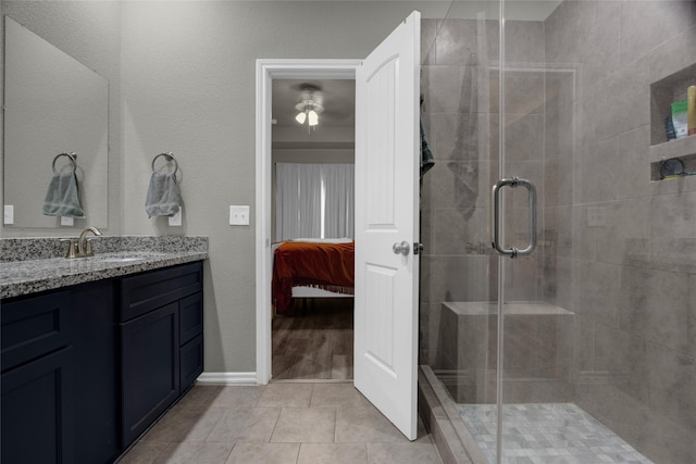 bathroom with vanity, tile patterned flooring, and an enclosed shower