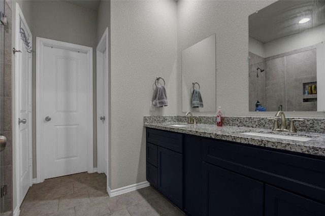 bathroom with vanity and tiled shower