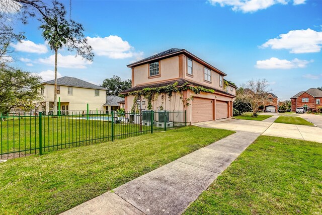 view of front of home with a garage and a front lawn