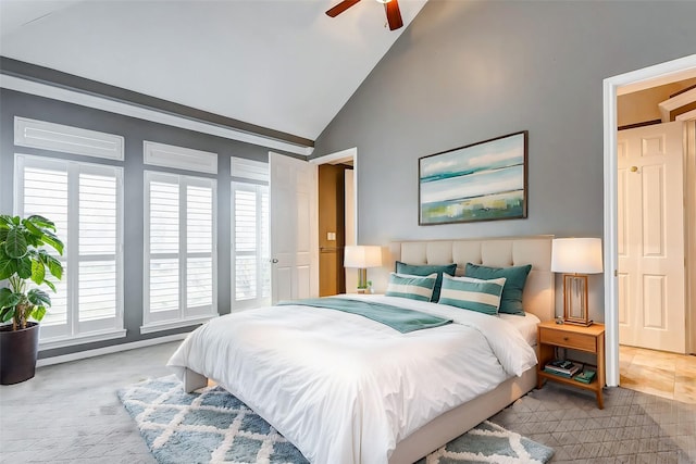 bedroom featuring light carpet, high vaulted ceiling, and a ceiling fan