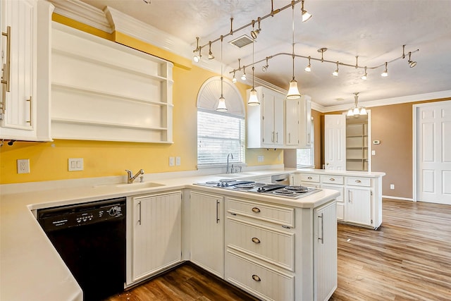 kitchen featuring dishwasher, pendant lighting, kitchen peninsula, crown molding, and white cabinets