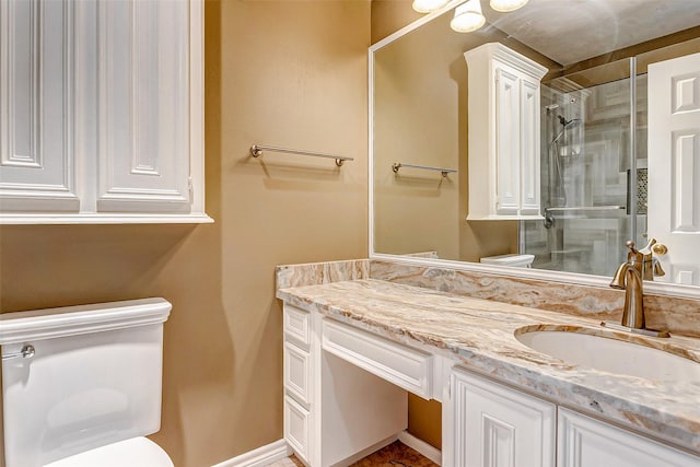 bathroom with toilet, vanity, and walk in shower