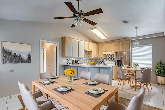 dining space with ceiling fan, light tile patterned floors, and lofted ceiling