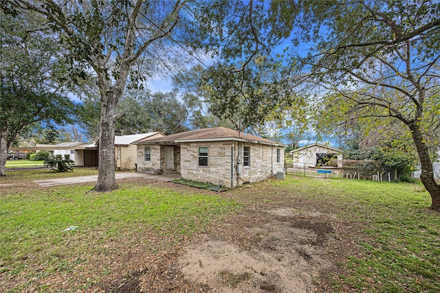 rear view of house with a yard and central AC