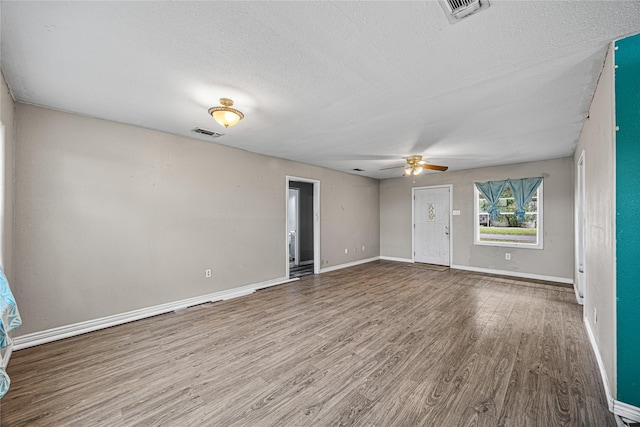 unfurnished living room with ceiling fan, hardwood / wood-style floors, and a textured ceiling