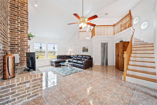 living room with ceiling fan, a fireplace, and high vaulted ceiling