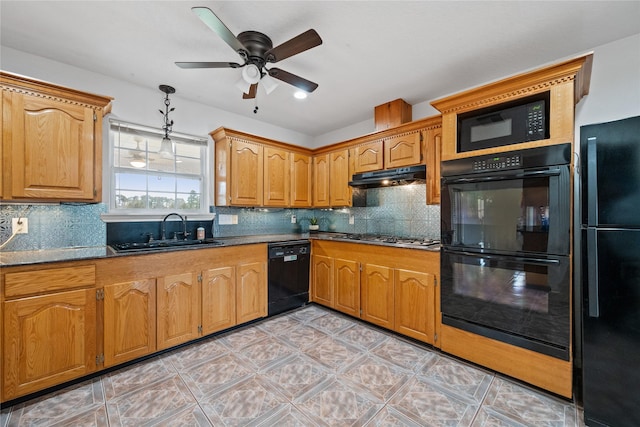 kitchen with ceiling fan, dark stone countertops, hanging light fixtures, black appliances, and sink