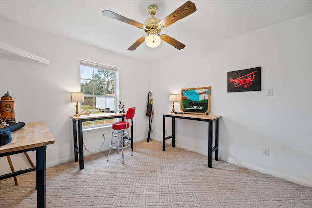 carpeted office space featuring ceiling fan