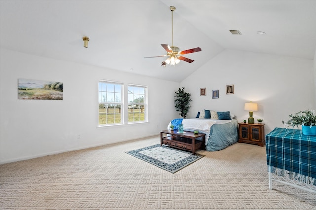 carpeted bedroom with ceiling fan and vaulted ceiling