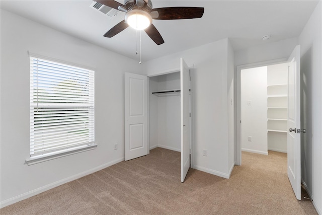 unfurnished bedroom featuring ceiling fan and light carpet