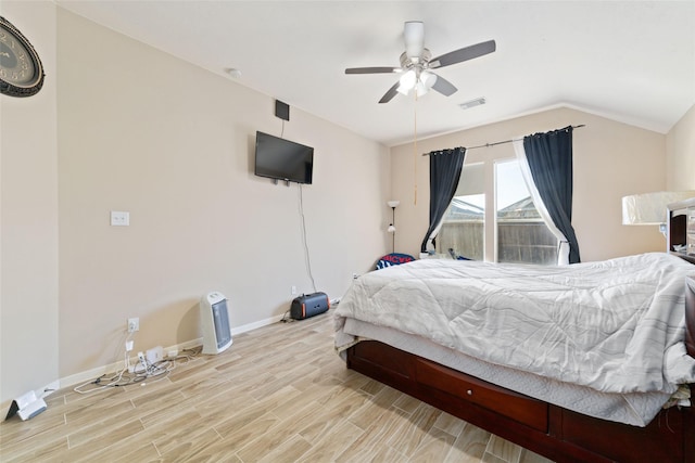 bedroom featuring lofted ceiling, ceiling fan, and light wood-type flooring