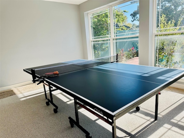 game room featuring carpet and a water view