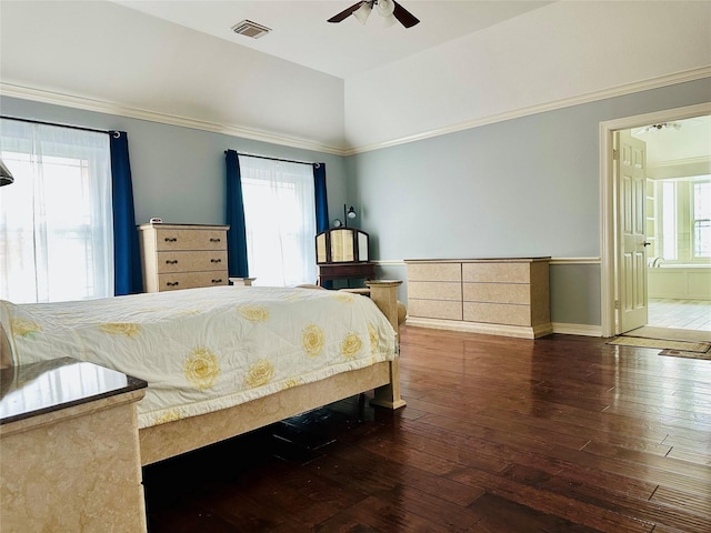 bedroom featuring vaulted ceiling, ornamental molding, dark hardwood / wood-style floors, and ceiling fan