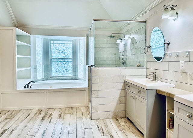 bathroom with vanity, tile walls, crown molding, and plus walk in shower