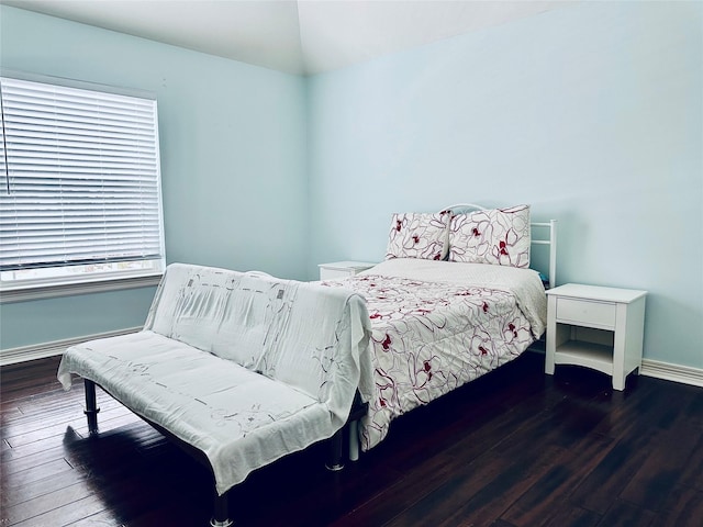 bedroom with lofted ceiling and dark hardwood / wood-style flooring