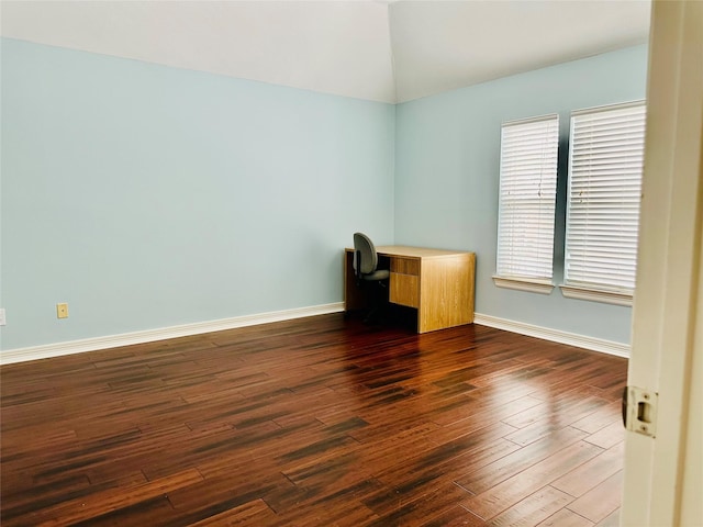 unfurnished office with dark hardwood / wood-style flooring and lofted ceiling