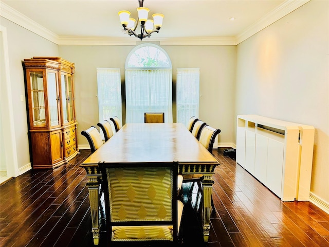 dining room with a notable chandelier, dark wood-type flooring, and ornamental molding