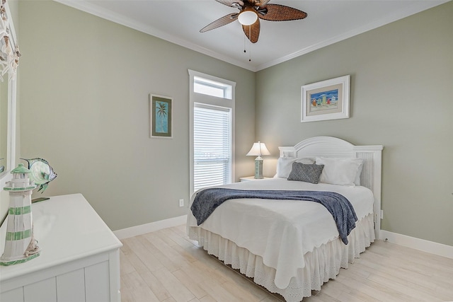 bedroom featuring ceiling fan, light wood-type flooring, and crown molding