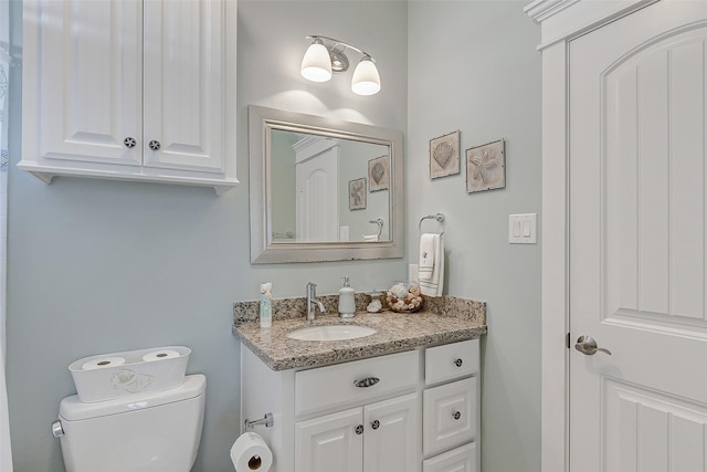 bathroom featuring toilet and vanity