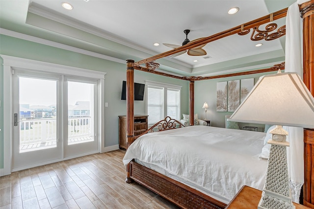 bedroom featuring ceiling fan, crown molding, a tray ceiling, and access to outside