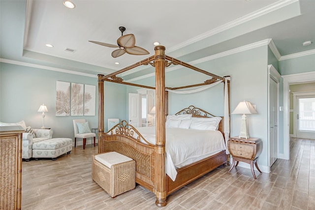 bedroom with ceiling fan, crown molding, and light hardwood / wood-style floors