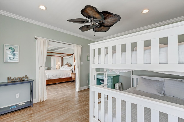 bedroom with ceiling fan, ornamental molding, and hardwood / wood-style flooring