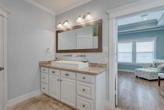 bathroom with vanity and ornamental molding