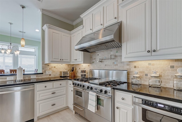 kitchen featuring white cabinetry, appliances with stainless steel finishes, tasteful backsplash, hanging light fixtures, and crown molding