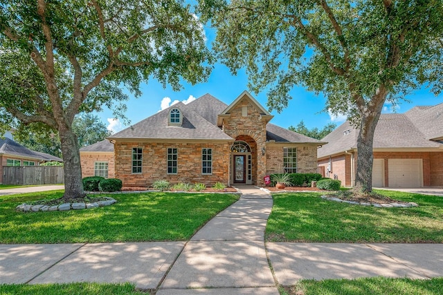 view of front of property with a front lawn and a garage