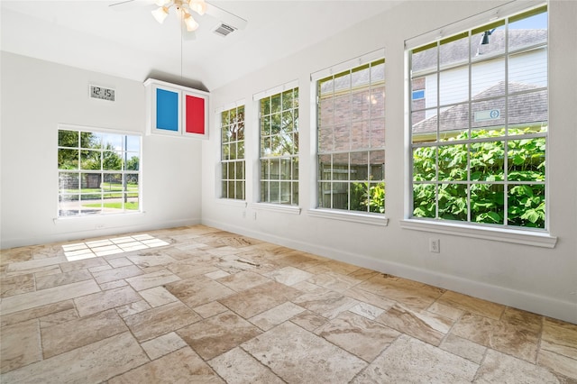 unfurnished sunroom featuring ceiling fan